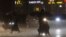 People walk and drive under heavy rain as the Typhoon Haikui approaches the country, in Taipei, Sept. 2, 2023.
