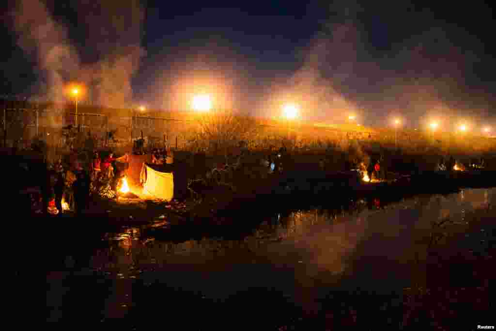 Група мигранти кампуваат покрај граничниот ѕид на американската страна на Рио Гранде во Ел Пасо, Тексас.