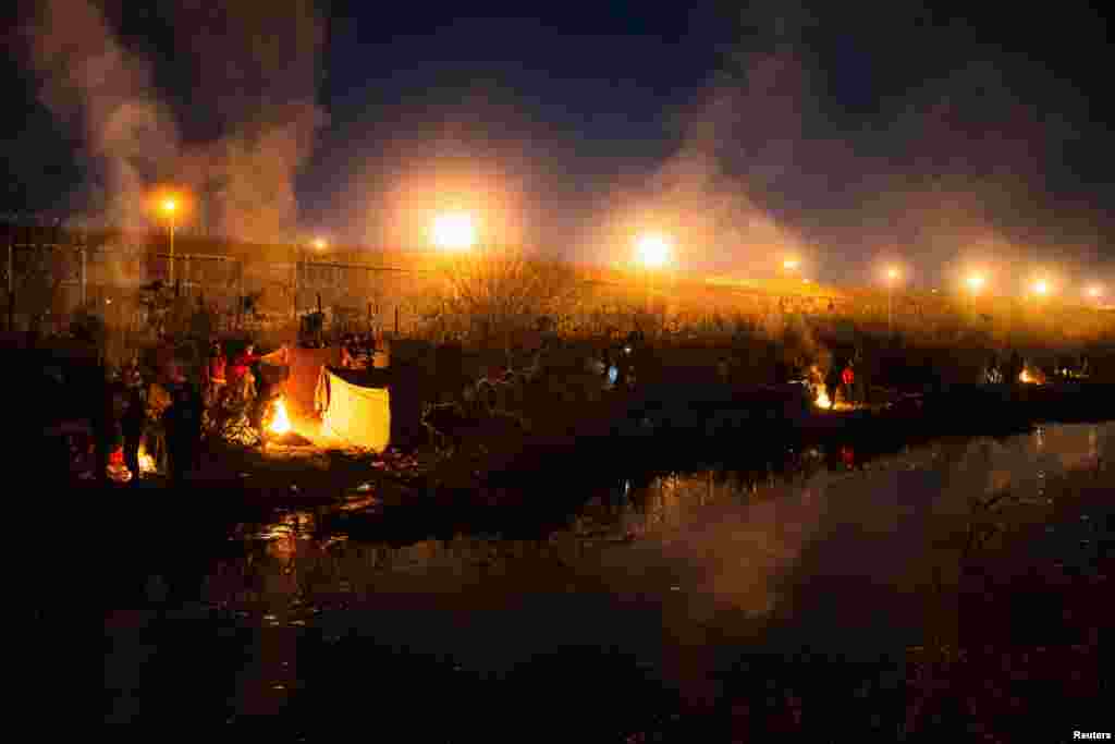 A group of migrants camp out along the border wall on the U.S. side of the Rio Grande in El Paso, Texas, as seen from Ciudad Juarez, Mexico, March 19, 2024. The U.S. Supreme Court let a Republican-backed Texas law known as SB 4 take effect, allowing state law enforcement authorities to arrest people suspected of crossing the U.S.-Mexico border illegally.