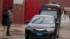 FILE - A police officer salutes a car carrying a judge in Rawalpindi, Pakistan, Jan. 30, 2024. A vehicle carrying three judges was ambushed in Tank, in the Khyber Pakhtunkhwa district, on Aug. 2, 2024, killing two police officers.