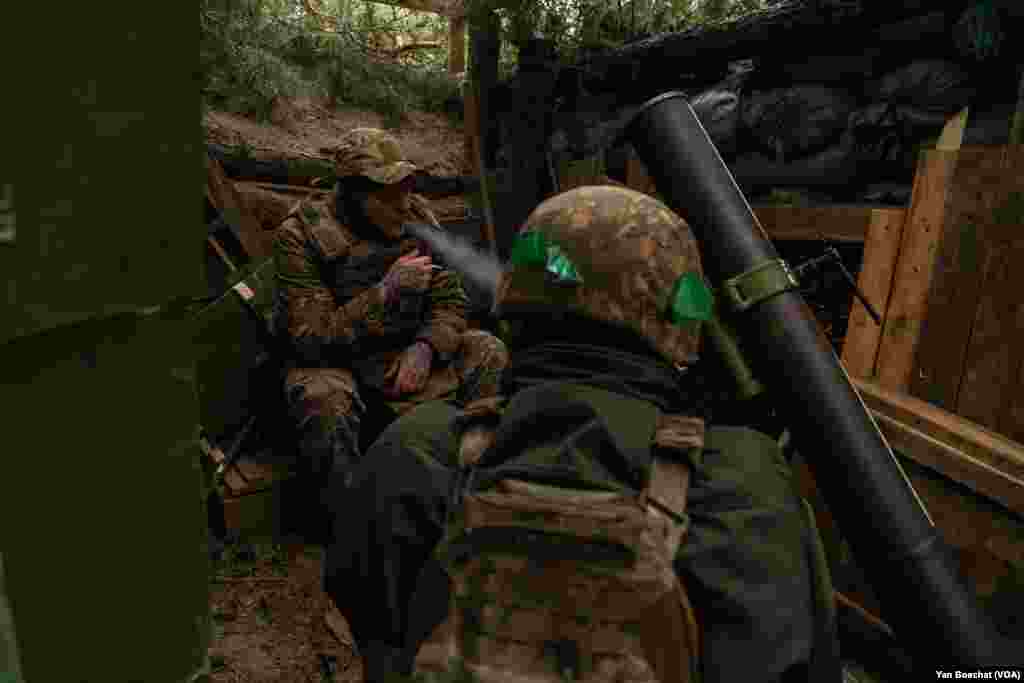 Soldiers wait for orders to fire mortars in an artillery position on the front lines of the Kreminna forest, March 7, 2024.