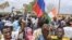 Supporters of Niger's coup leaders hold a Russian flag as they gather for a demonstration in Niamey on Aug. 11, 2023, near a French airbase in Niger. 