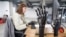 FILE - Olena Pozniakova, 28, a quality assurance engineer, tests the app for bionic prostheses at the Esper Bionics office in Kyiv, Ukraine, Oct. 31, 2023. 