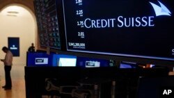 A sign displays the name of Credit Suisse on the floor at the New York Stock Exchange in New York, March 15, 2023.