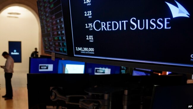 A sign displays the name of Credit Suisse on the floor at the New York Stock Exchange in New York, March 15, 2023.