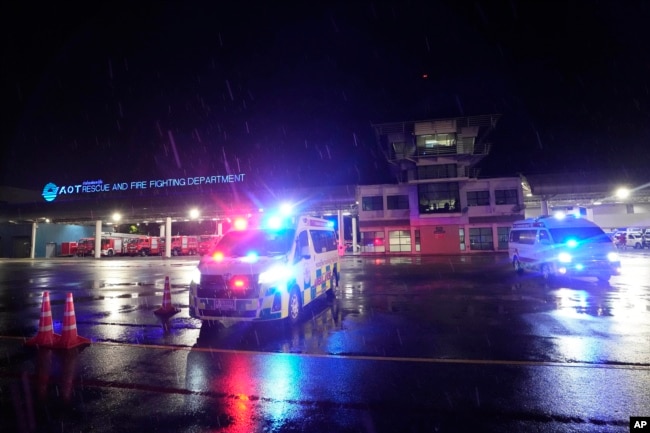 Ambulances are seen at the airport where a London-Singapore flight that encountered severe turbulence was diverted to, in Bangkok, Thailand, Tuesday, May 21, 2024. (AP Photo/Sakchai Lalit)