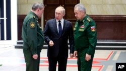 FILE - Russian President Vladimir Putin, center, with Chief of the General Staff Gen. Valery Gerasimov, (L), Russian Defense Minister Sergei Shoigu, Moscow, Russia, Dec. 21, 2022.