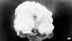 FILE - The mushroom cloud rises from the first atomic explosion at Trinity Test Site near Alamagordo, N.M., July 16, 1945. Fourteen U.S. prosecutors are backing efforts to compensate people sickened by exposure to radiation during nuclear weapons testing.