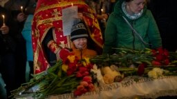 FILE - Mykhail Shulha, center, cries next to the coffin of his 11-year-old sister, Sofia Shulha, during her funeral in Uman, central Ukraine, April 30, 2023. Sofia was among those killed in a Russian attack on one of the city's residential buildings.