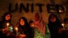 FILE - Thai-Muslim students hold a candlelight vigil for victims of the Tak Bai shooting on its third anniversary, outside the United Nations building in Bangkok, Oct. 25, 2007. 