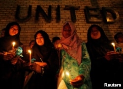 FILE - Thai-Muslim students hold a candlelight vigil for victims of the Tak Bai shooting on its third anniversary, outside the United Nations building in Bangkok, Oct. 25, 2007.