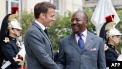 France's President Emmanuel Macron (L) shakes hands with Gabon's President Ali Bongo Odimba for a meeting to prepare a summit for a new global financial pact at the Elysee Palace in Paris, on June 21, 2023.