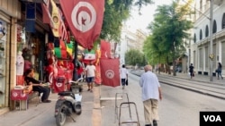 Tunisian flags, prized after the revolution, are less in demand as the political and economic mood sours. (Lisa Bryant/VOA)