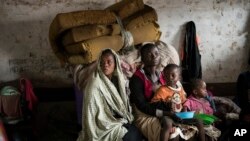 Mothers and their children are seen at a displacement center in Blantyre, Malawi, March 14, 2023. The unrelenting Cyclone Freddy that is currently battering southern Africa has killed more than 50 people in Malawi and Mozambique since it struck the continent for a second time.