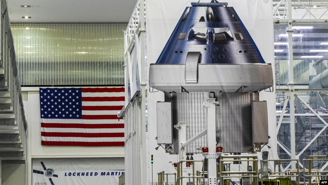 Sebuah poster yang memperlihatkan kapsul Orion untuk misi Artemis II dipajang di dalam Gedung Operasi dan Pemeriksaan (O&C) di Kennedy Space Center di Cape Canaveral, Florida, 28 Agustus 2022. (CHANDAN KHANNA / AFP)