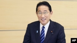 FILE - In photo by the Cabinet Public Affairs Office, Japanese Prime Minister Fumio Kishida eats seafood from Fukushima prefecture at his office in Tokyo, Japan, Aug. 30, 2023.