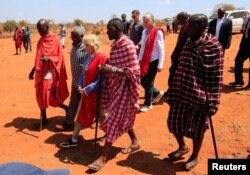 US first lady Jill Biden walks with traditional Maasai elders at the drought response site, during a visit to highlight the impacts of drought relief at the Lositeti village in Matapato North, Kajiado County, Kenya, Feb. 26, 2023.