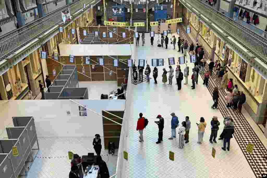 People line up to vote at a school in Brussels, Belgium, June 9, 2024.