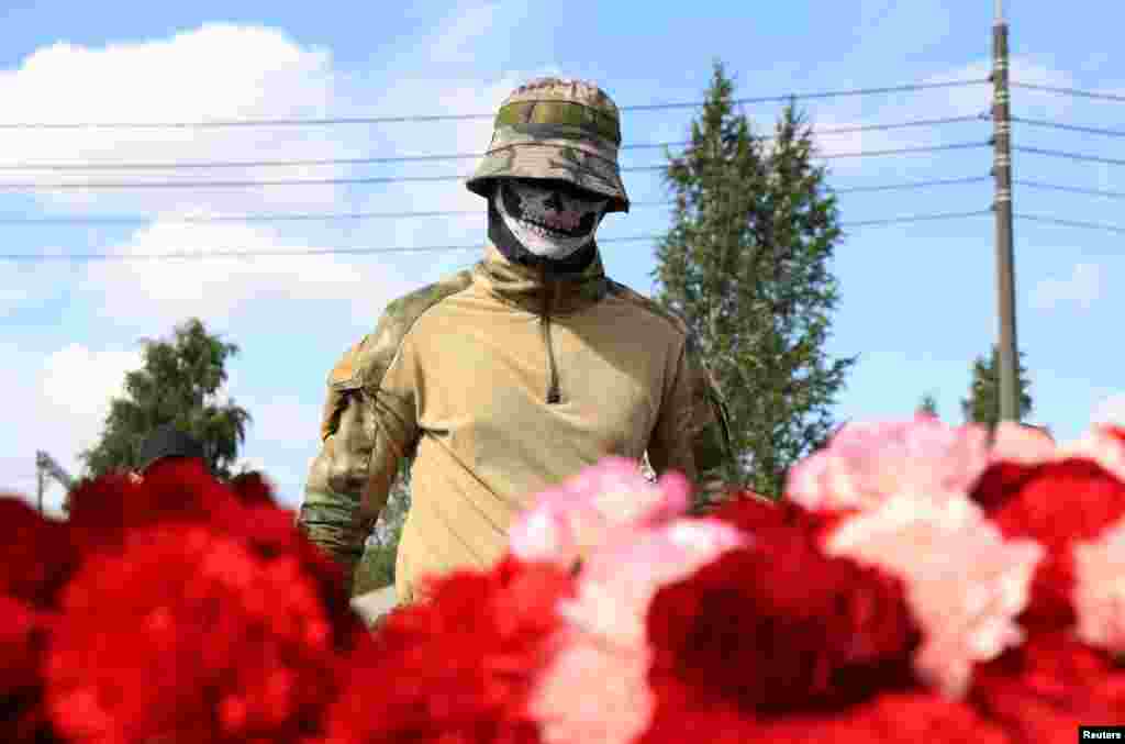 A fighter of Wagner private mercenary group visits a makeshift memorial near former PMC Wagner Centre, associated with the founder of the Wagner Group, Yevgeny Prigozhin, in Saint Petersburg, Russia.