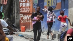 Residents flee their homes to escape clashes between armed gangs in Port-au-Prince, Haiti, on Aug. 15, 2023.