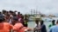In this photo provided by the Philippine Coast Guard, rescuers carry the body of one of the victims as it arrives at a port in Infanta, Pangasinan province, Philippines, Oct. 3, 2023.(Philippine Coast Guard via AP)