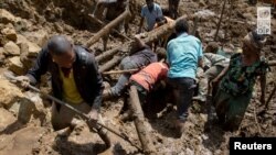 27일 대규모 산사태로 피해를 입은 파푸아뉴기니 북부 엥가 주의 카오칼람 마을 주민들이 정리 작업을 진행 중이다.