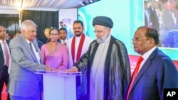 Iranian President Ebrahim Raisi, second right, and Sri Lankan President Ranil Wickremesinghe, in grey suit, inaugurate the Uma Oya project in Uma Oya, some 180 km east of Colombo, Sri Lanka, April 24, 2024. (Sri Lanka President's Office via AP) 