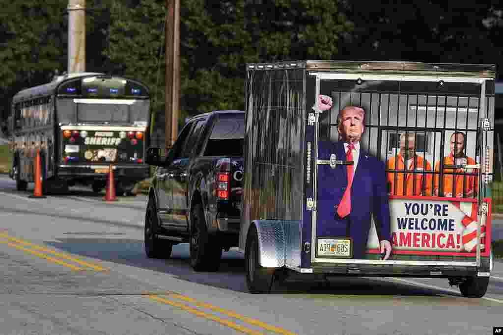 A vehicle and trailer drive by the Fulton County Jail, in Atlanta. Trump is accused of scheming to subvert the will of Georgia voters to keep the Republican president in the White House after he lost to Democrat Joe Biden.