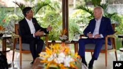 FILE - U.S. President Joe Biden, right, listens to British Prime Minister Rishi Sunak during a meeting on the sidelines of the G-20 summit meeting, in Nusa Dua, Bali, Indonesia, Nov. 16, 2022. 