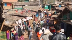 FILE - In this image from a video, Rohingya refugees walk at the Balukhali refugee camp in Cox's Bazar, Bangladesh, Feb. 2, 2021.