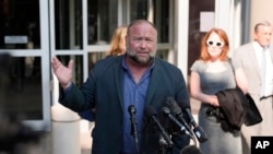 Conspiracy theorist Alex Jones speaks outside a federal courthouse after a bankruptcy hearing in Houston, Texas, June 14, 2024.