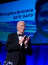 President Joe Biden applauds as an image of Austin Tice, an American journalist detained in Syria, appears on screen at the White House Correspondents' Association Dinner, April 27, 2024, in Washington. 