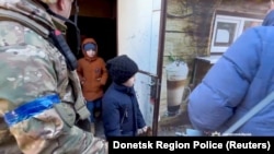 Residents evacuate Avdiivka in the Donetsk Region of Ukraine, in this screen grab from a handout video released on March 8, 2023. (Donetsk Region Police/Reuters)