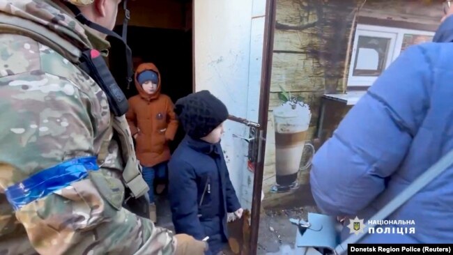 Residents evacuate Avdiivka in the Donetsk Region of Ukraine, in this screen grab from a handout video released on March 8, 2023. (Donetsk Region Police/Reuters)