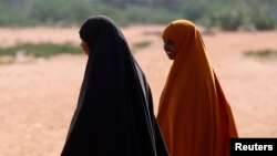 FILE: Women cross from Somalia into Kenya at the border line in town of Mandera. Taken Dec.11, 2014.