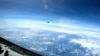 In this image from video provided by the U.S. Navy, a Chinese J-16 fighter flies close to a U.S. RC-135 aircraft in international airspace over the South China Sea on May 26, 2023. (U.S. Navy via AP)