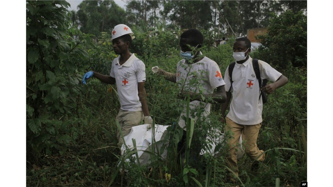 FILE - Red Cross volunteers carry the body of a civilian who was killed in the DRC village of Mukondi, on March 9, 2023. At least 36 people were killed when the Allied Democratic Forces attacked the village and burned residents' huts.