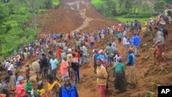 People are seen gathered at the site of a landslide in Gofa Zone, southern Ethiopia, July 22, 2024. (Isayas Churga/Gofa Zone Government Communication Affairs Department via AP)