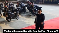 North Korea's leader Kim Jong Un walks to meet Russian President Vladimir Putin at the Pyongyang Sunan International Airport outside Pyongyang, June 19, 2024. 