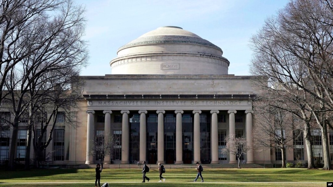 FILE - Students walk past the 'Great Dome' atop Building 10 on the Massachusetts Institute of Technology campus, April 3, 2017, in Cambridge, Mass.