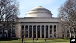 FILE - Students walk past the 'Great Dome' atop Building 10 on the Massachusetts Institute of Technology campus, April 3, 2017, in Cambridge, Mass. 