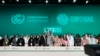 United Nations Climate Chief Simon Stiell, COP28 President Sultan al-Jaber and Hana al-Hashimi, chief COP28 negotiator for the United Arab Emirates, pose for photos at the end of the Climate Summit, Dec. 13, 2023, in Dubai. 