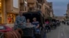 Domestic sightseers tour the ancient city of Luxor by horse carriage, following last year’s record-breaking traffic from abroad, which Egypt’s tourism ministry says surpassed the 2010 peak of 14.7 million arrivals, in Luxor, Egypt, Feb. 22, 2024. 