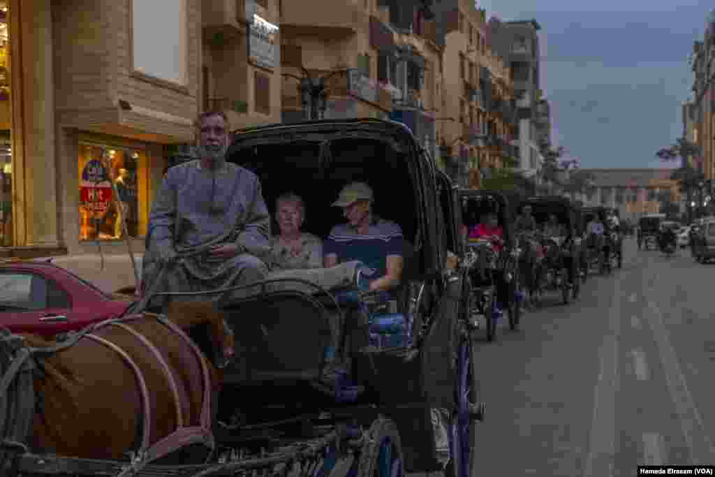 Domestic sightseers tour the ancient city of Luxor by horse carriage, following last year’s record-breaking traffic from abroad, which Egypt’s tourism ministry says surpassed the 2010 peak of 14.7 million arrivals, in Luxor, Egypt, Feb. 22, 2024. 