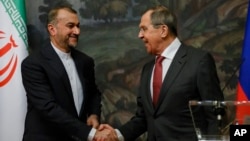 FILE - Russian Foreign Minister Sergey Lavrov, right, and Iranian Foreign Minister Hossein Amir-Abdollahian shake hands after a joint news conference following their talks in Moscow, Russia, March 29, 2023. Lavrov is to visit Tehran for talks Monday.