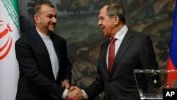 FILE - Russian Foreign Minister Sergey Lavrov, right, and Iranian Foreign Minister Hossein Amir-Abdollahian shake hands after a joint news conference following their talks in Moscow, Russia, March 29, 2023.