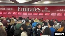 People queue at a flight connection desk at the Dubai International Airport, after flooding in Dubai, United Arab Emirates, April 17, 2024. 