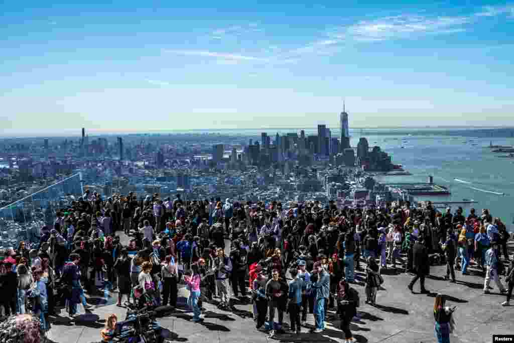 People gather on the observation deck of Edge at Hudson Yards before a partial solar eclipse in New York City, New York.
