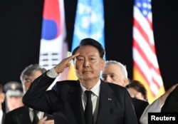FILE - South Korean President Yoon Suk Yeol salutes at Seoul Air Base in Seongnam, South Korea, July 26, 2023.