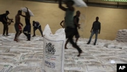 People collect bags of fertilizer in Lilongwe, Malawi, on March 6, 2023. The Russian government has donated 20,000 tons of fertilizer to Malawi as part of its efforts to garner diplomatic support from various African nations.